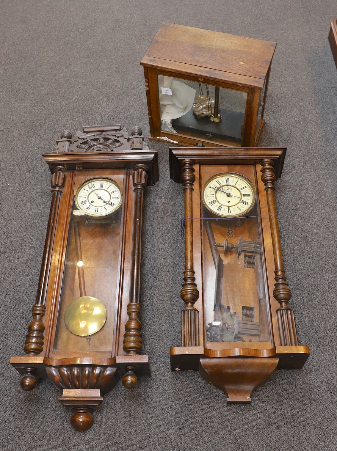 Two late 19th / early 20th century Vienna type wall clocks, larger 119 cms and a set of oak cased scientific beam scales.